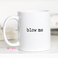 White mug with 'blow me' text on a white background