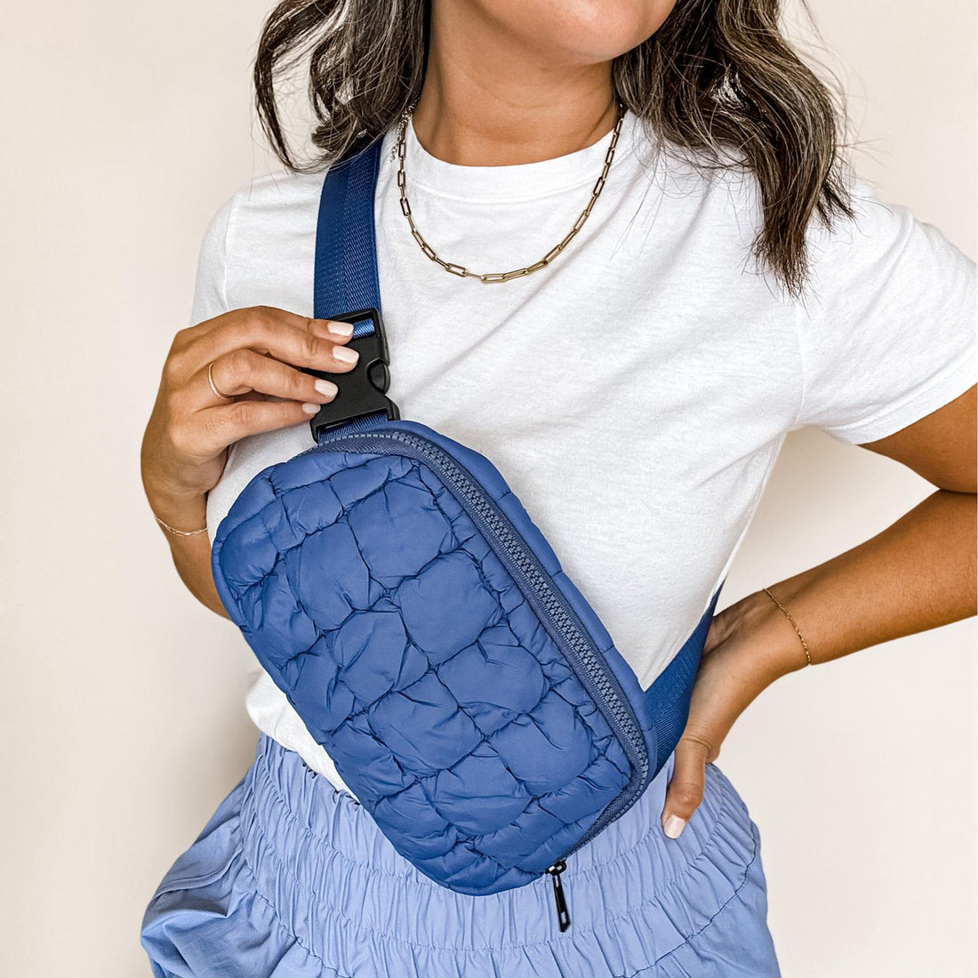 Blue quilted belt bag with zipper closure for women