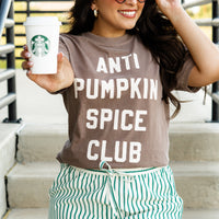 Woman wearing an 'ANTI PUMPKIN SPICE CLUB' t-shirt, holding a Starbucks cup.