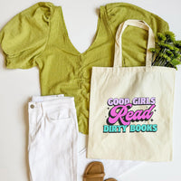 Green top, white pants, brown sandals, and a tote bag with text on a white background