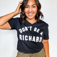 Woman wearing a black t-shirt with 'DON'T BE A RICHARD' text on a white background