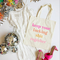 Tote bag with text, disco balls, and high heels on a white surface
