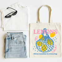 White t-shirt, blue jeans, sunglasses, and a tote bag with 'LEMONS' design on a white background