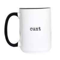Offensive one-word coffee mug with black typewriter text reading "cunt" on a white mug with black accent handle and rim