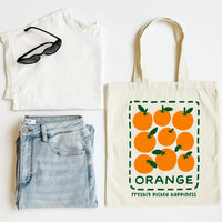 White t-shirt, blue jeans, sunglasses, and a tote bag with orange design on a white background