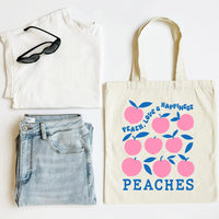White tank top, blue jeans, sunglasses, and a tote bag with 'Peach, Love & Happiness' design on a white background