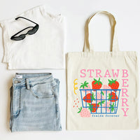 White tank top, blue jeans, sunglasses, and a tote bag with strawberry design on a white background