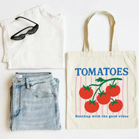 White t-shirt, blue jeans, sunglasses, and a tote bag with tomato design on a white background