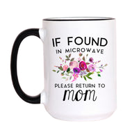 A white ceramic mug with a black handle and black rim, featuring a floral graphic and the text 'IF FOUND IN MICROWAVE PLEASE RETURN TO mom' on a white background.