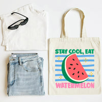 White t-shirt, blue jeans, sunglasses, and tote bag with watermelon design on a white background
