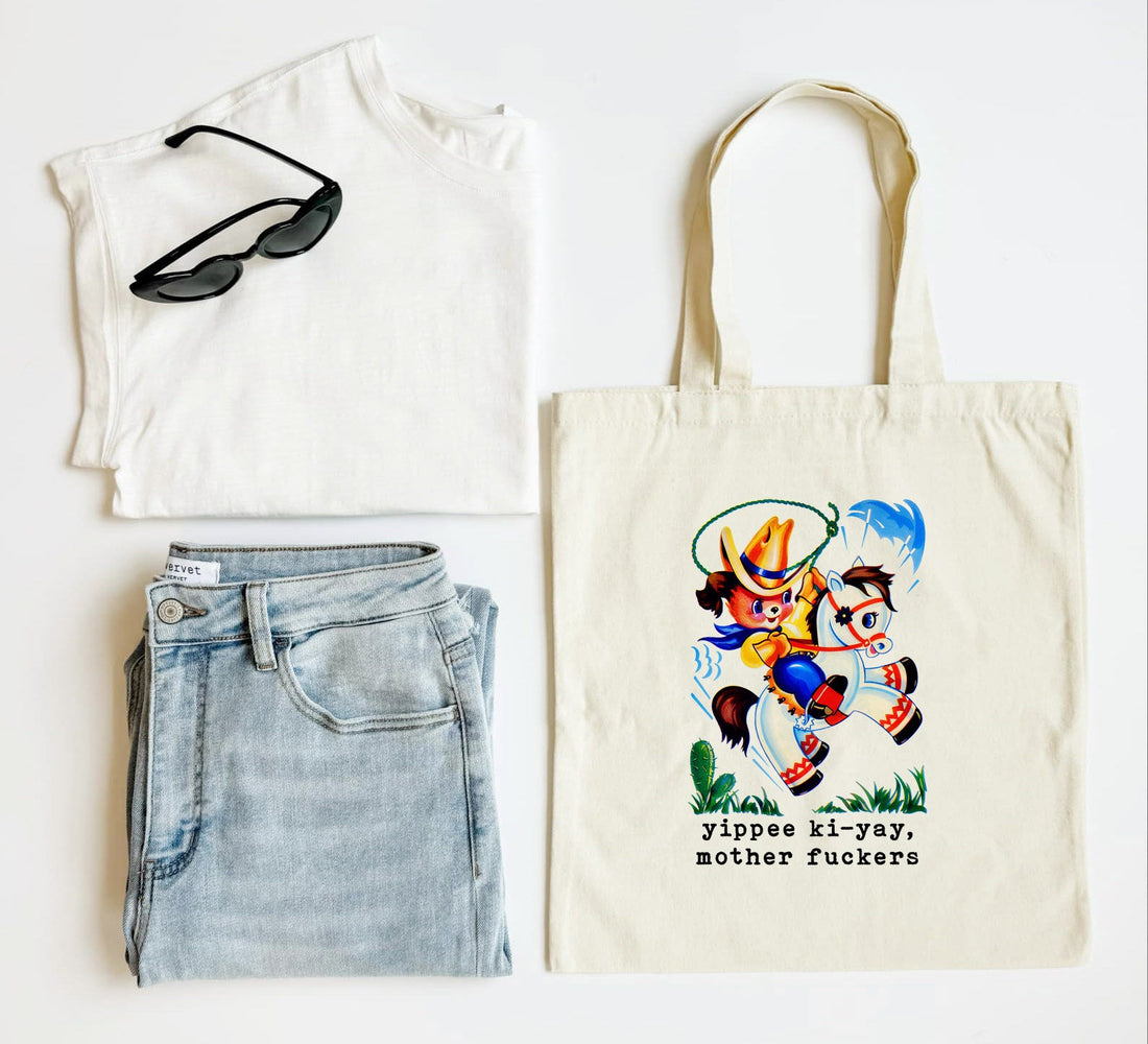 White tank top, blue jeans, sunglasses, and a tote bag with a colorful design and text on a white background.