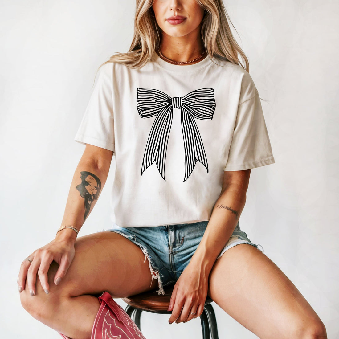 Ivory comfort colors tee with large black striped coquette bow graphic – trendy girly shirt