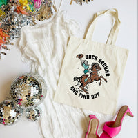 Tote bag with a horse and rider graphic and text, surrounded by disco balls and high heels on a white surface.
