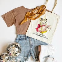 T-shirt, shorts, scarf, and tote bag with cat illustration on a white background