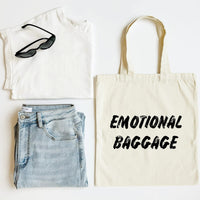 White tank top, blue jeans, black sunglasses, and a tote bag with 'EMOTIONAL BAGGAGE' text on a white background.