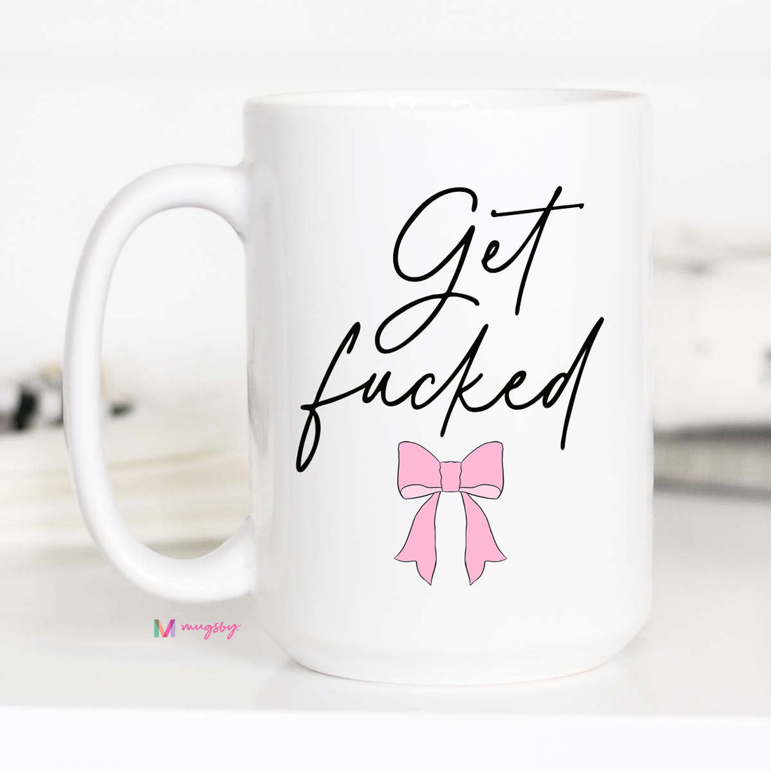 White mug with black text and a pink bow on a white background