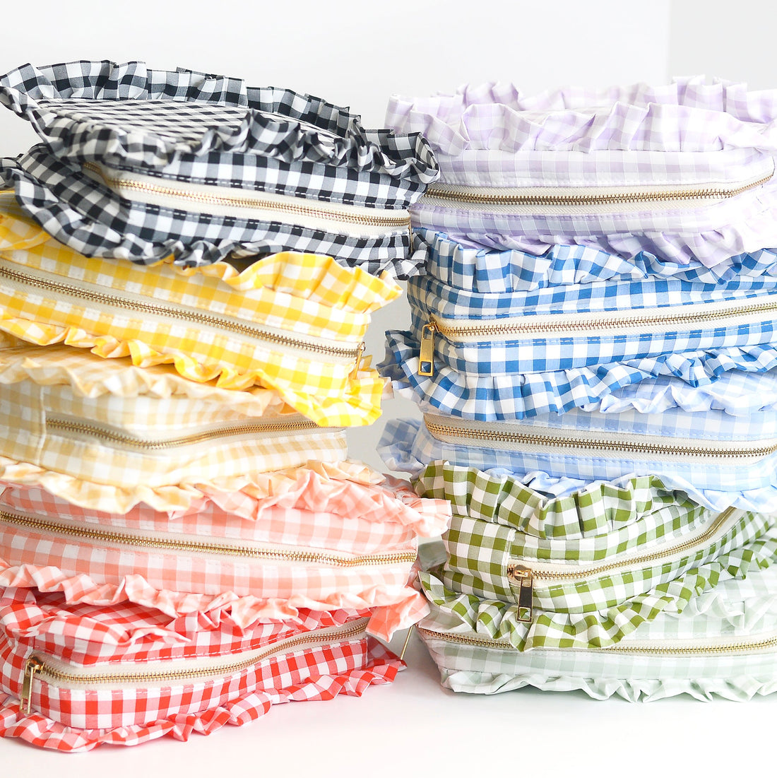 Stack of colorful checkered bags with zippers on a white background