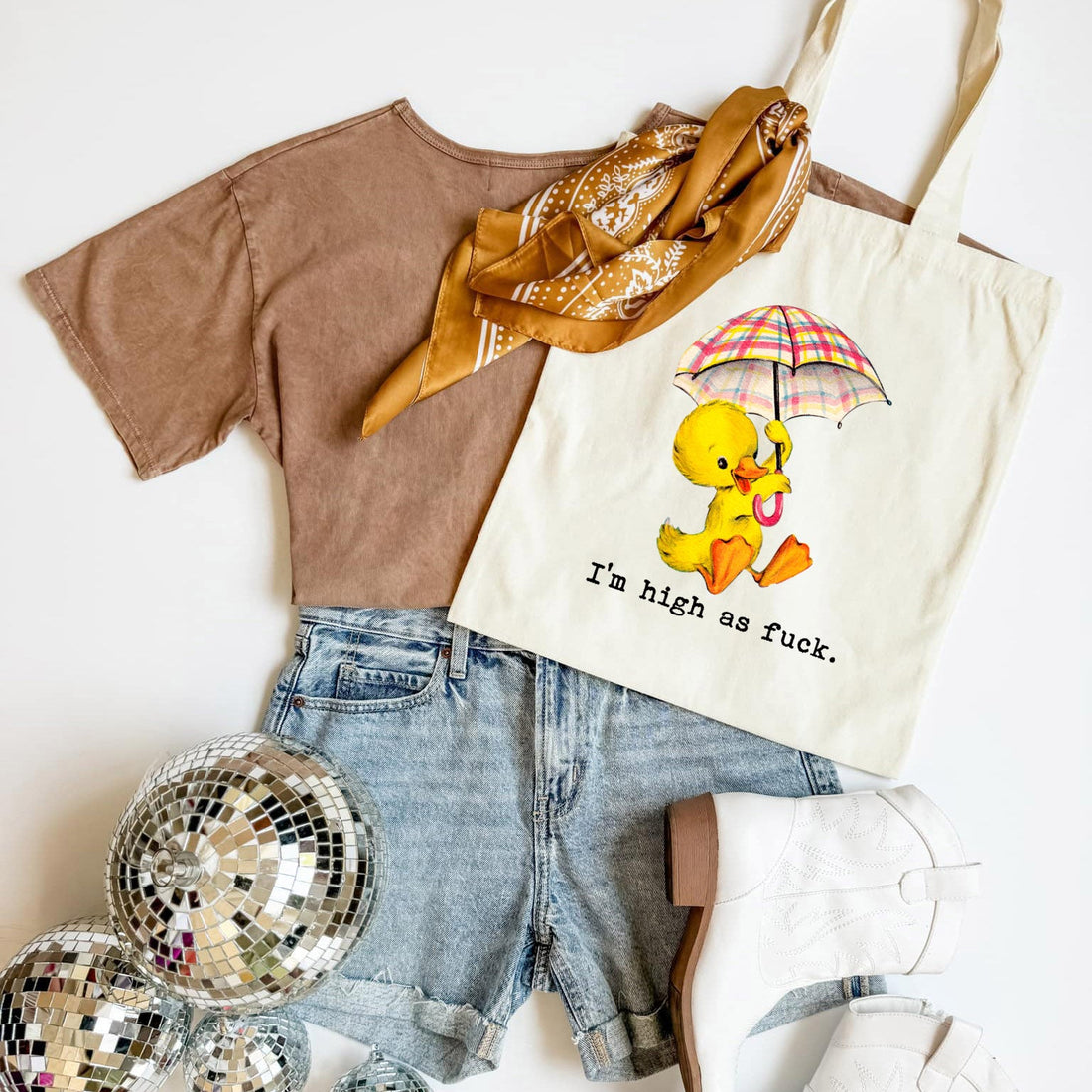 T-shirt, shorts, scarf, and tote bag with a duck graphic on a white background