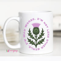 White mug with a thistle design and text on a white background