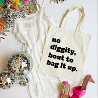 Tote bag with text 'no diggity, bout to bag it up.' on a white surface with disco balls and high heels.