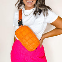 Orange quilted puffer waist pack for hands-free style