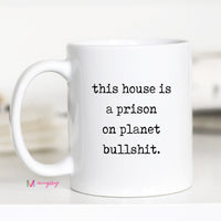 White mug with black text on a white background