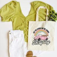Green top, white pants, and tote bag with a pink car and rainbow design on a white background