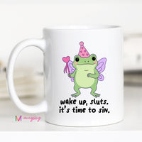 White mug with a cartoon frog fairy design and text on a white background