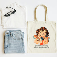 White tank top, blue jeans, sunglasses, and a tote bag with a graphic design on a white background