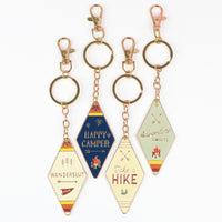Camp Collection Soft Enamel Keychains - Happy Camper, Take a Hike, Adventure Awaits, and Wanderslut designs.
