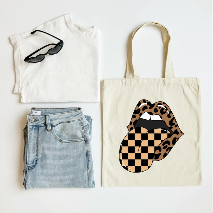 T-shirt, jeans, sunglasses, and tote bag with checkered lips design on a white background