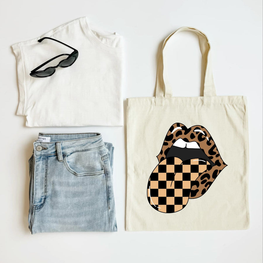 T-shirt, jeans, sunglasses, and tote bag with checkered lips design on a white background
