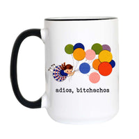 A white ceramic mug with a black handle and black rim, featuring a colorful graphic of a girl floating on balloons and the text 'adios, bitchachos' printed below.