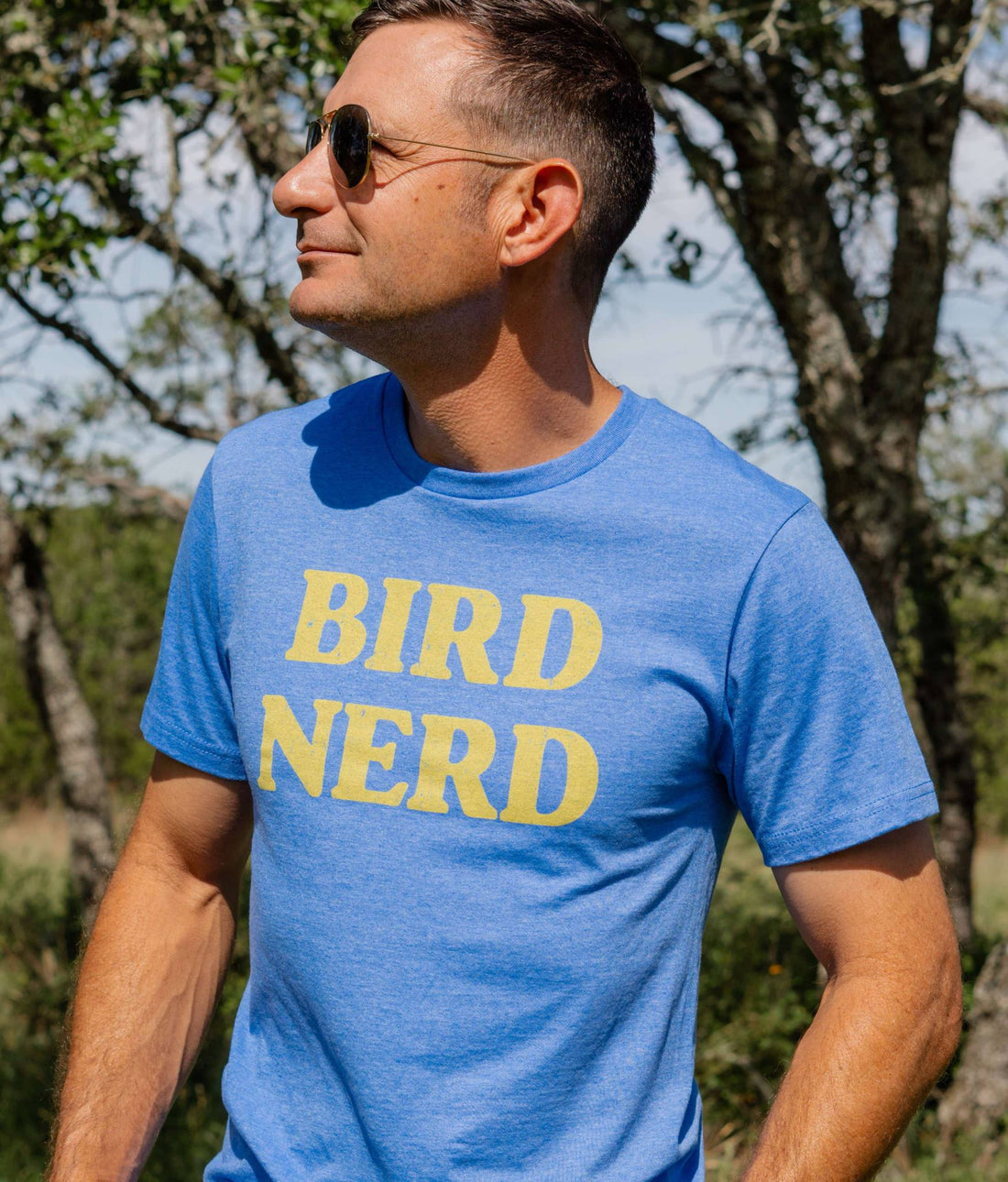 A person wearing a blue t-shirt with the text &