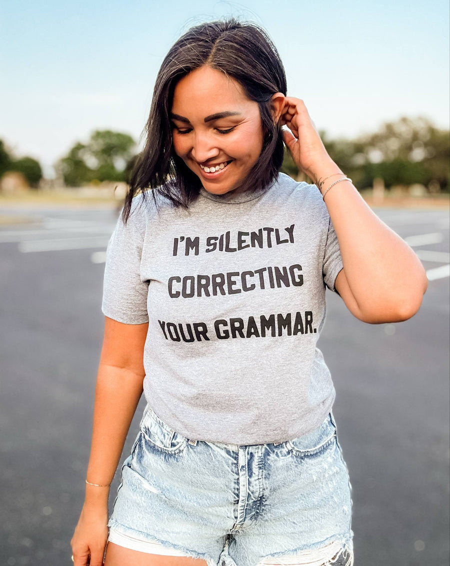 Woman wearing a Graphic t-shirt that says 'I’m Silently Correcting Your Grammar' – funny editor and teacher shirt

