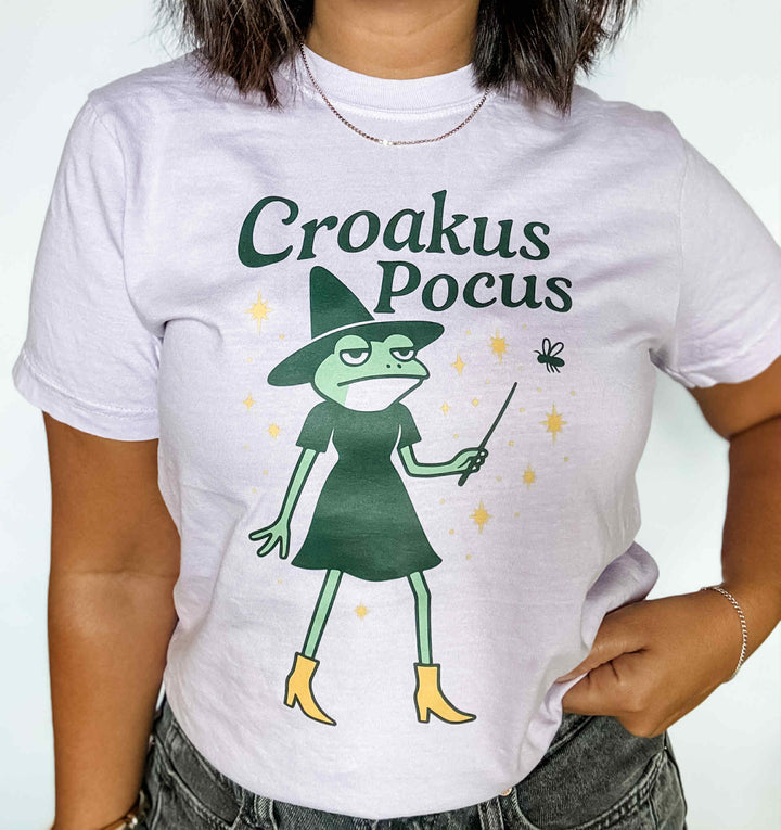 Graphic tee that says 'Croakus Pocus' with frogs in costume – funny Halloween shirt