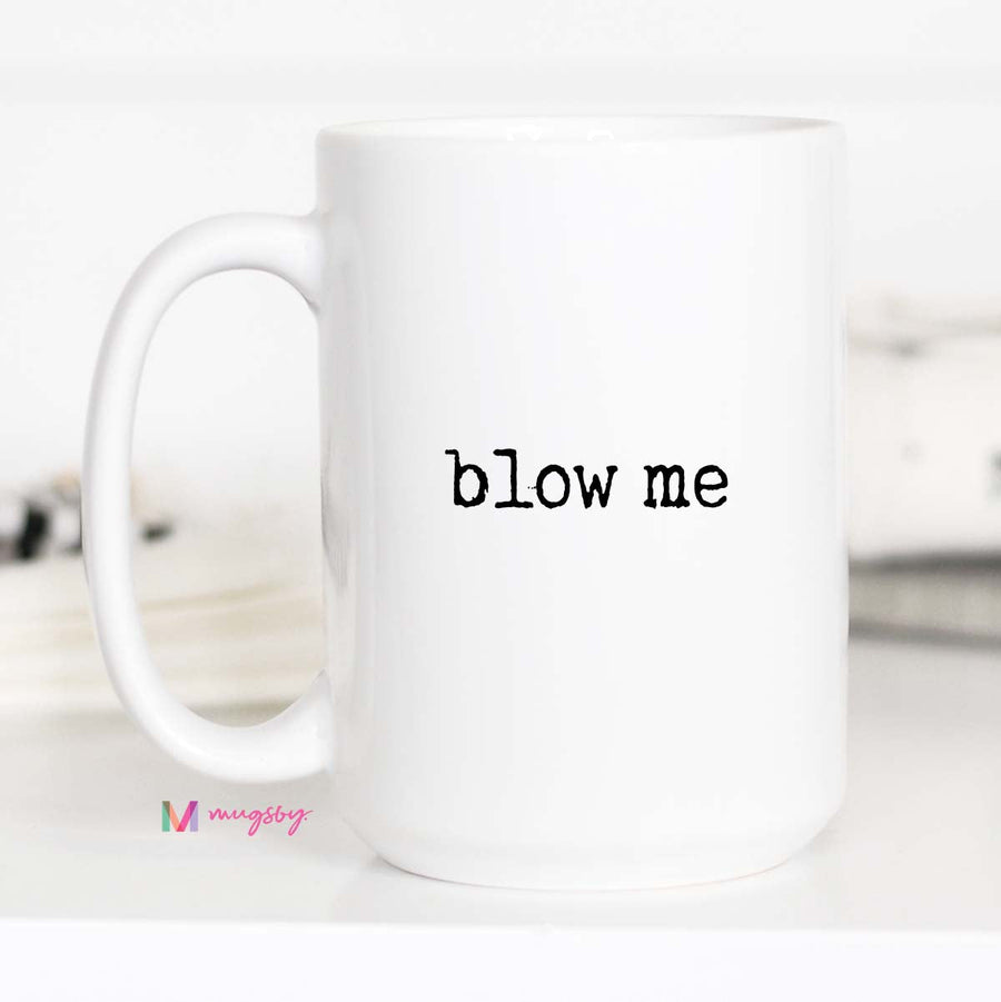 White mug with 'blow me' text on a white background