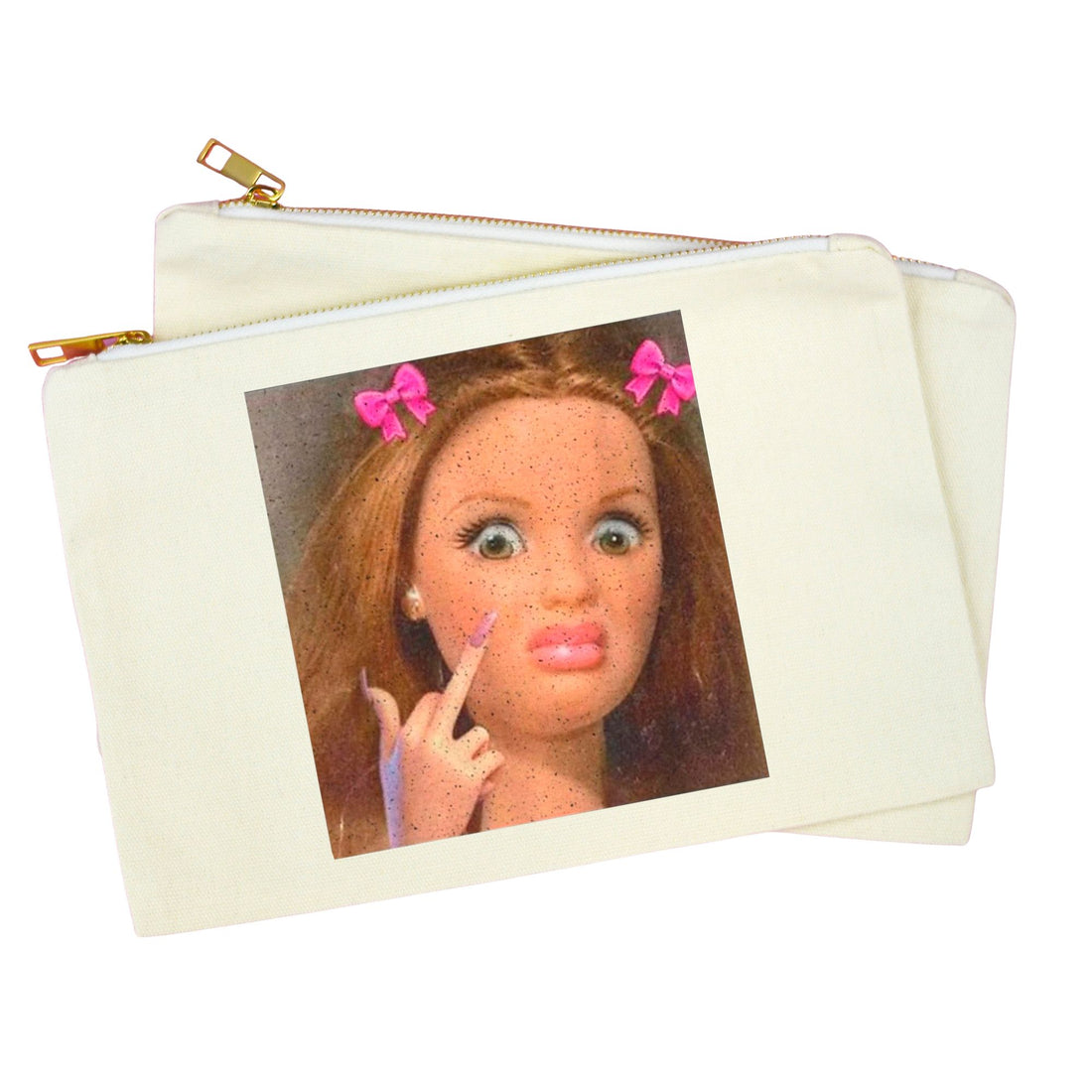 An off-white canvas zipper pouch with a gold zipper, featuring a printed graphic of a doll with pink bows in her hair. The pouch is shown against a plain white background.