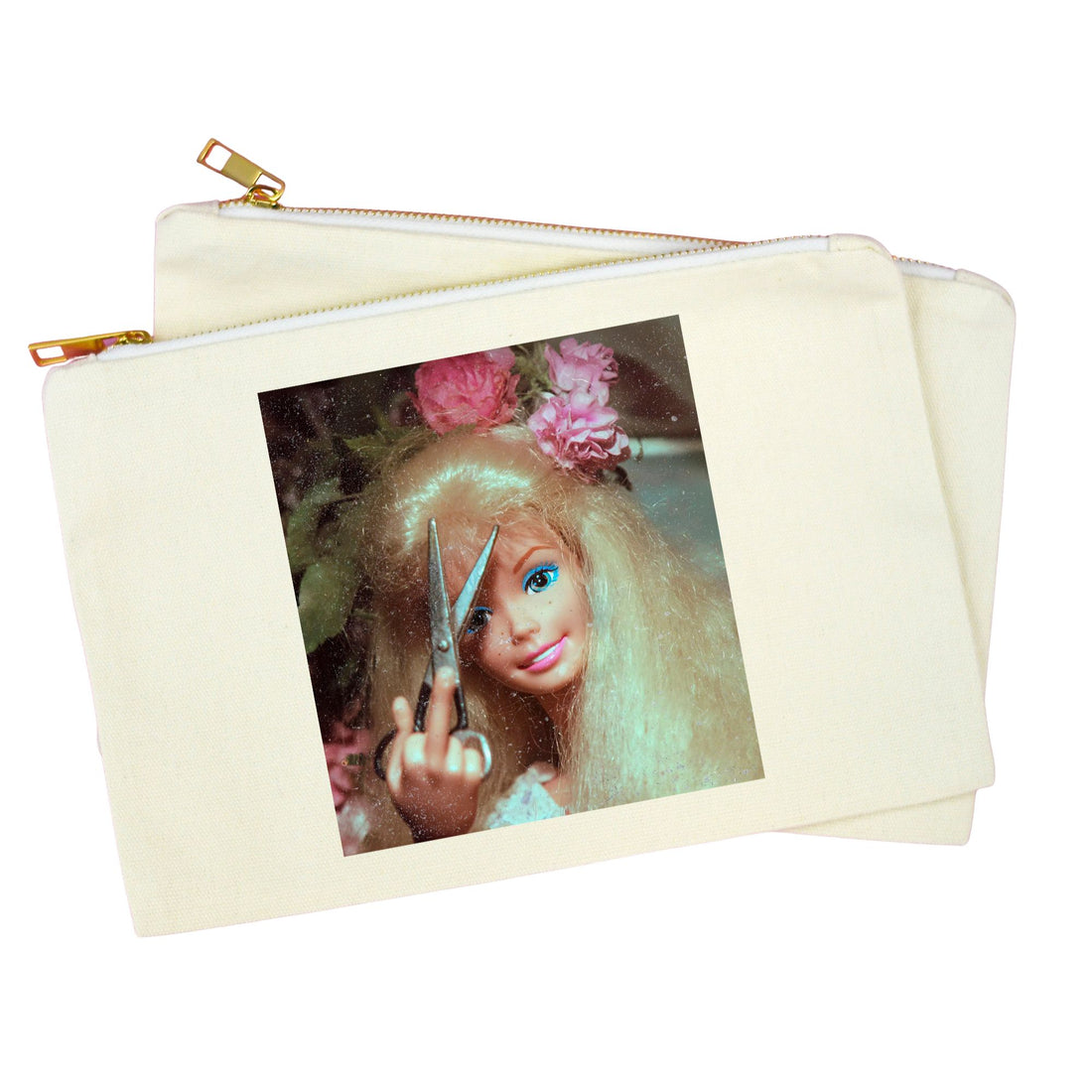A cream-colored canvas zipper pouch with a gold zipper, featuring a printed graphic of a doll with blonde hair, pink flowers, and scissors on the front.