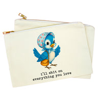 An off-white canvas zipper pouch featuring a cartoon illustration of a blue bird wearing a floral bonnet and carrying an orange purse, with the text 'i'll shit on everything you love' printed below. The pouch is shown with a second pouch layered behind it on a plain white background.