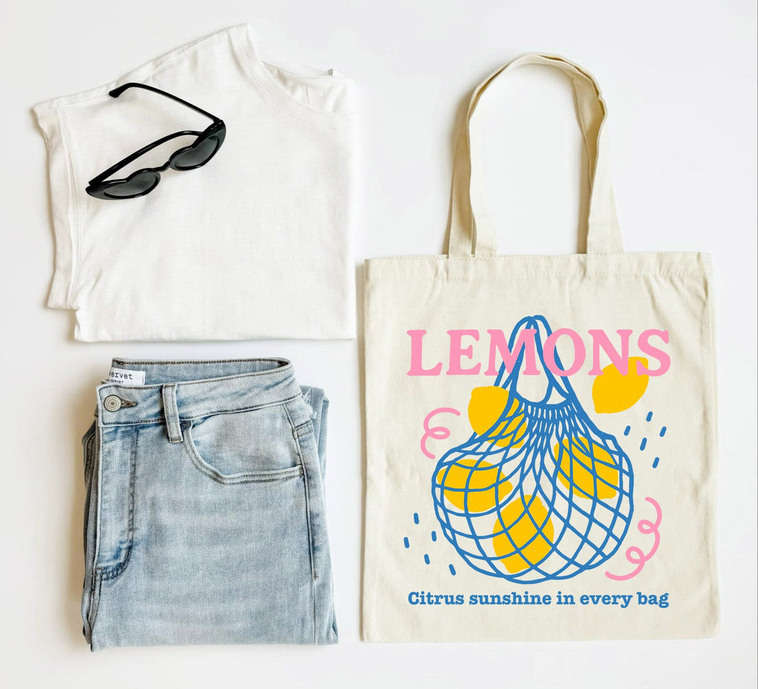 White t-shirt, blue jeans, sunglasses, and a tote bag with &