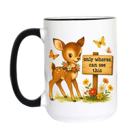 A white ceramic mug with a black handle and black rim, featuring a cartoon illustration of a fawn, flowers, butterflies, and a wooden sign that reads 'only whores can see this'.