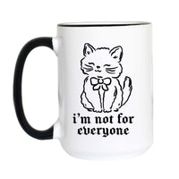 A smug kitten in a bow says what your therapist calls "healthy boundaries." The sassy cat mug for acquired tastes and proud ones at that. 