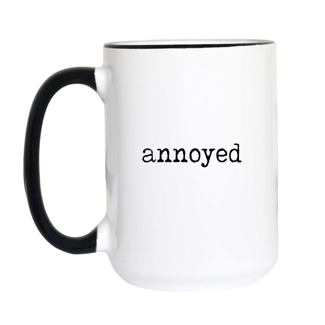 Funny mood coffee mug with black typewriter text reading "annoyed" on a white mug with black accent handle and rim