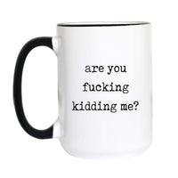  Funny sweary coffee mug with black typewriter text reading "are you fucking kidding me?" on a white mug with black accent handle and rim