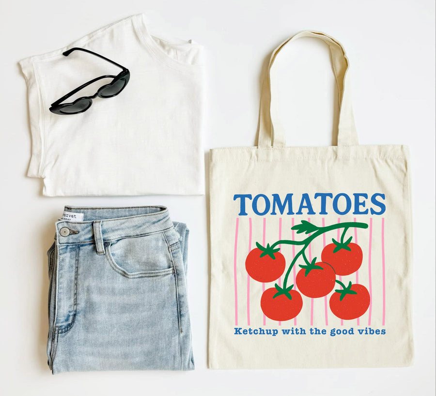 White t-shirt, blue jeans, sunglasses, and a tote bag with tomato design on a white background