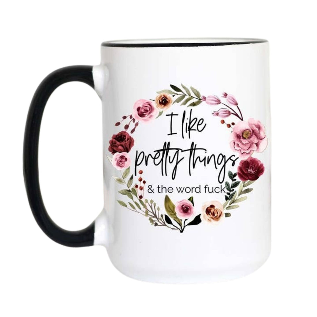 A white ceramic mug with a black handle and black rim, featuring a floral wreath graphic and the text &