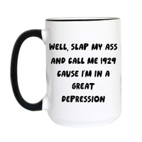 A white ceramic coffee mug with a black handle and black rim, featuring the text 'WELL, SLAP MY ASS AND CALL ME 1929 CAUSE I'M IN A GREAT DEPRESSION' printed in black on the front.