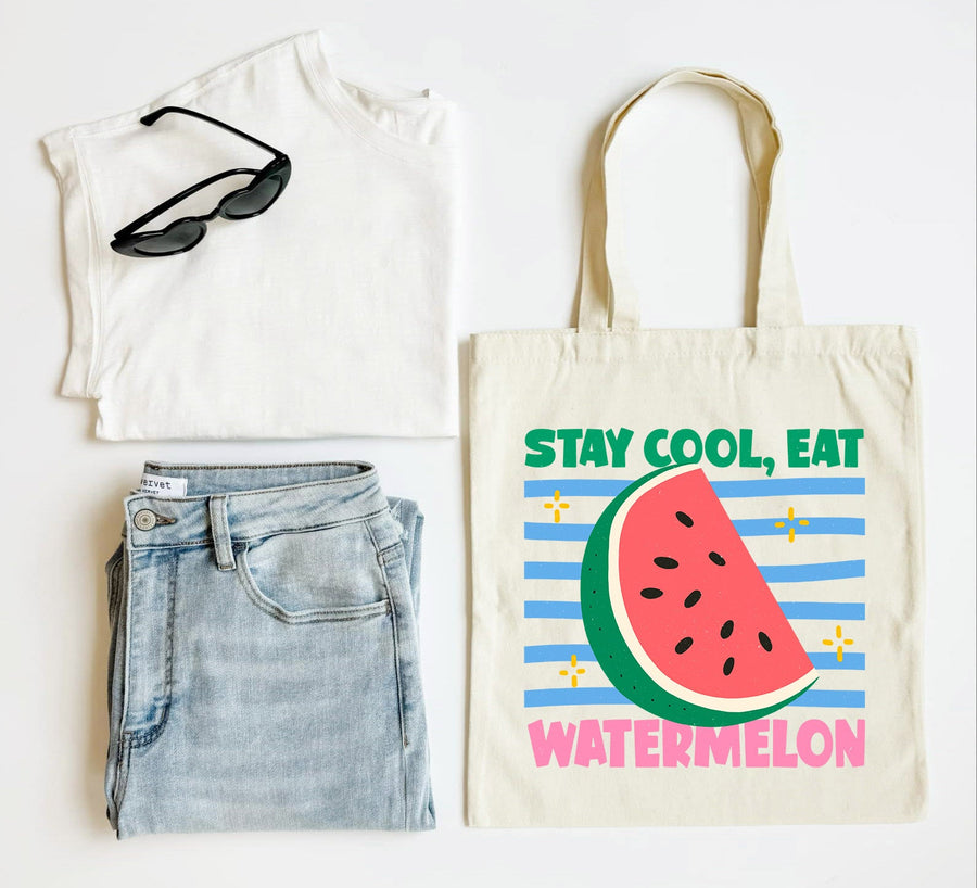 White t-shirt, blue jeans, sunglasses, and tote bag with watermelon design on a white background