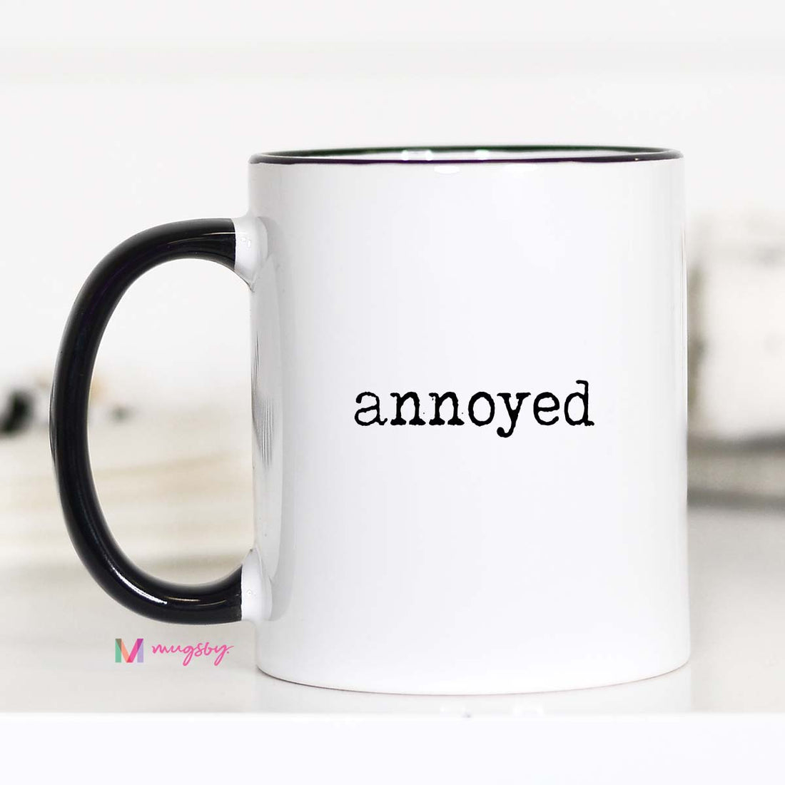White mug with black handle and &